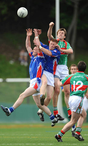 Mayo’s Ronan McGarrity rises with two Mayo-born New York players, Dermot Keane from Knockmore (left) and Robert Moran from Foxford. Photo © Mayo News